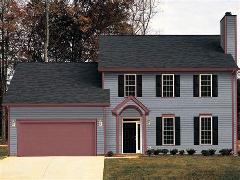 grey siding house with dark grey metal roof|grey house with black awnings.